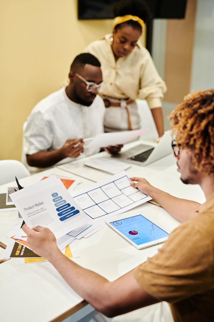 Mastering the First Impression: Your intriguing post title goes here Team of professionals collaborating on documents and laptops in a modern office.